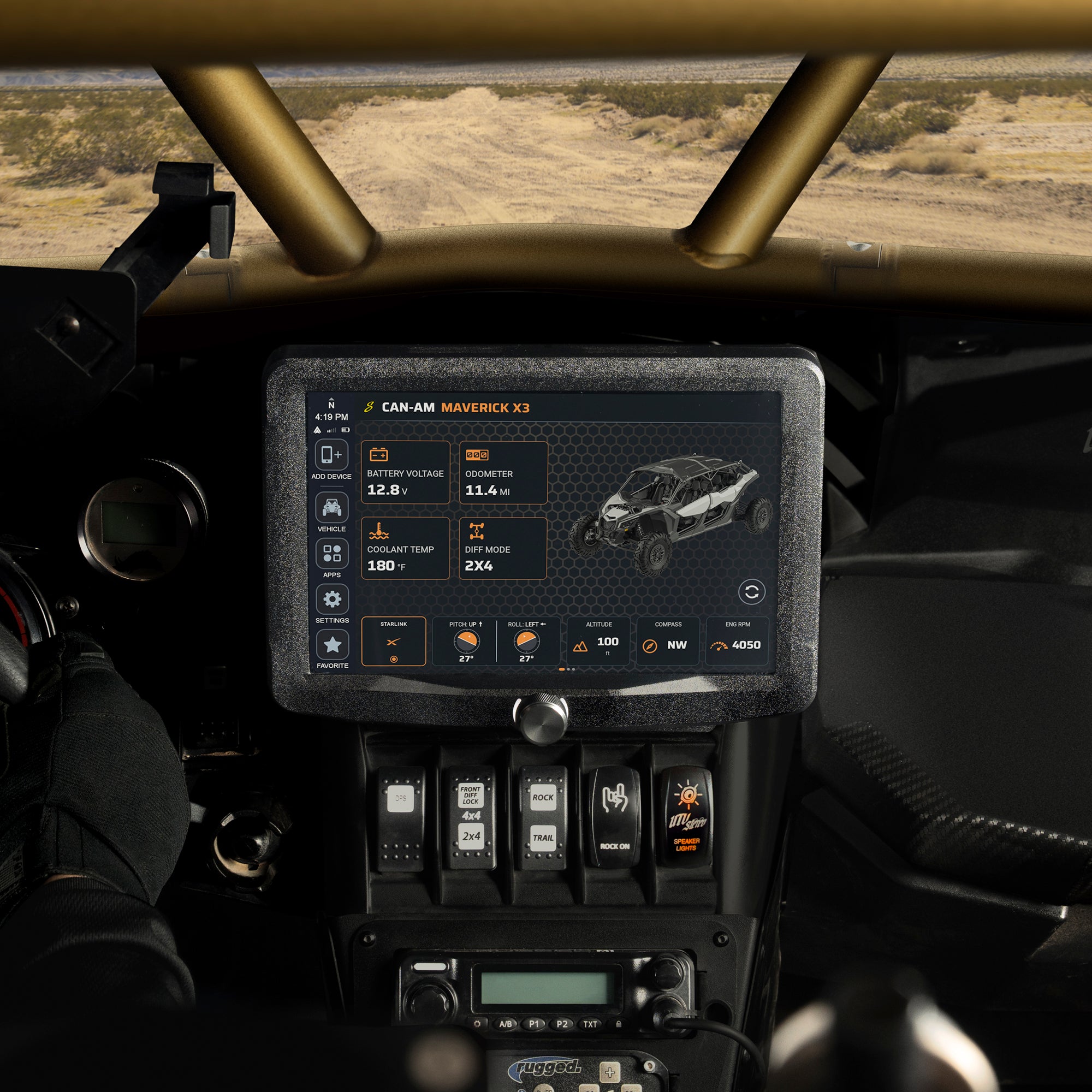 Driver's view of the Stinger HORIZON XTR in a Can-Am Maverick X3 showing live vehicle data, desert trail through the roll cage
