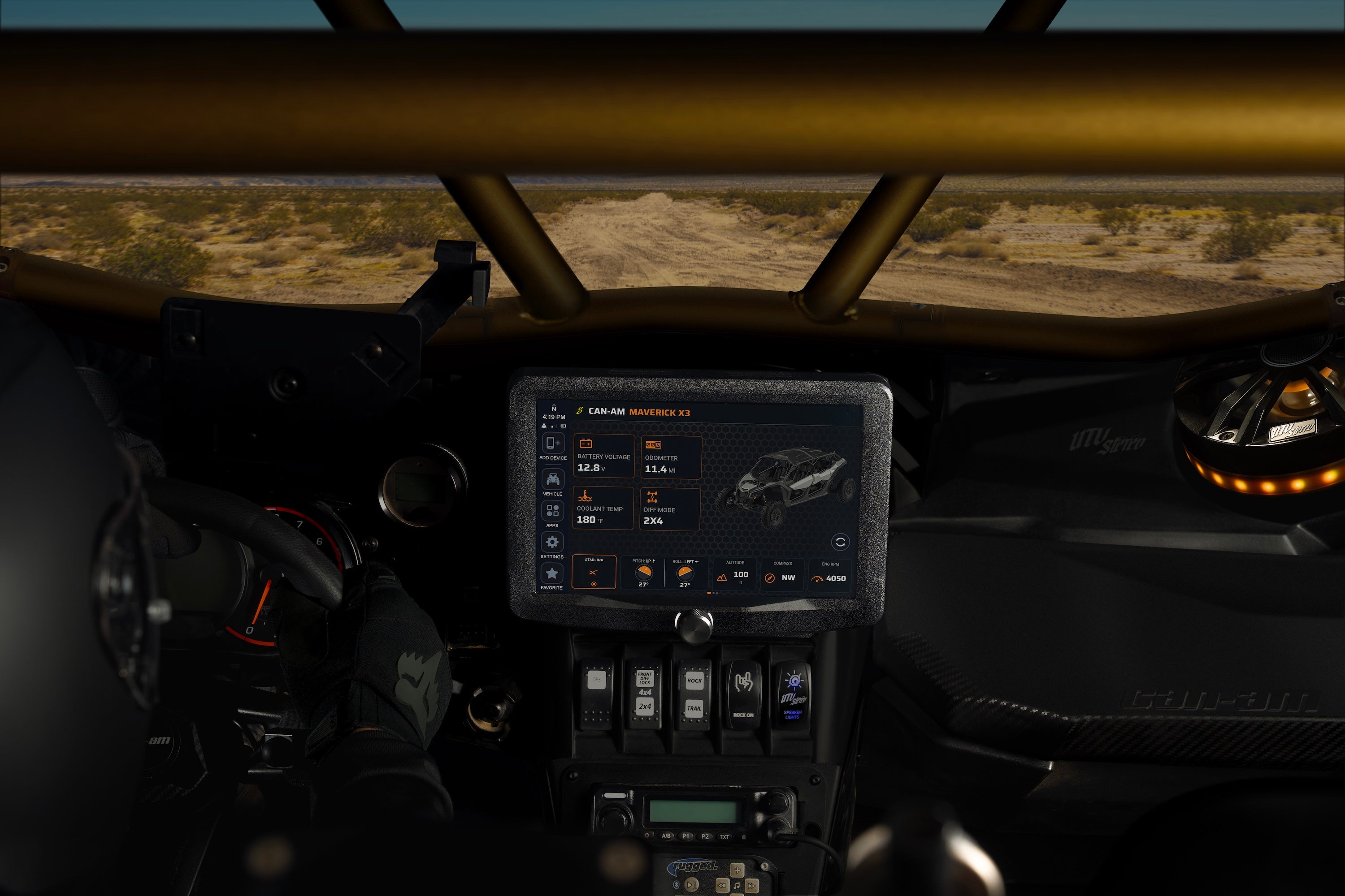 Zoomed out view of a Can-Am Maverick X3 interior in the desert with a HORIZON XTR multi-function display.