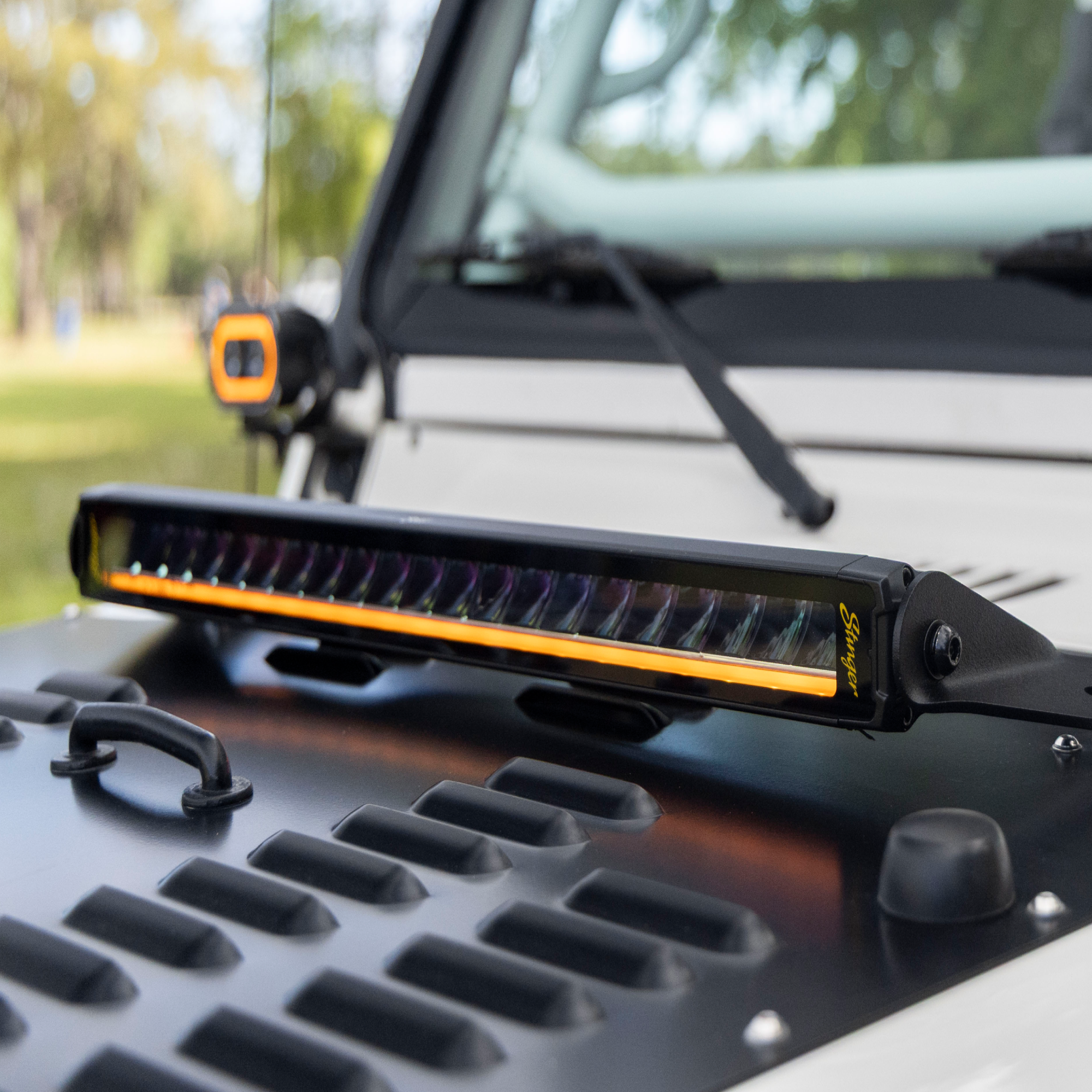 LED light bar on a vehicle with a blurred natural background
