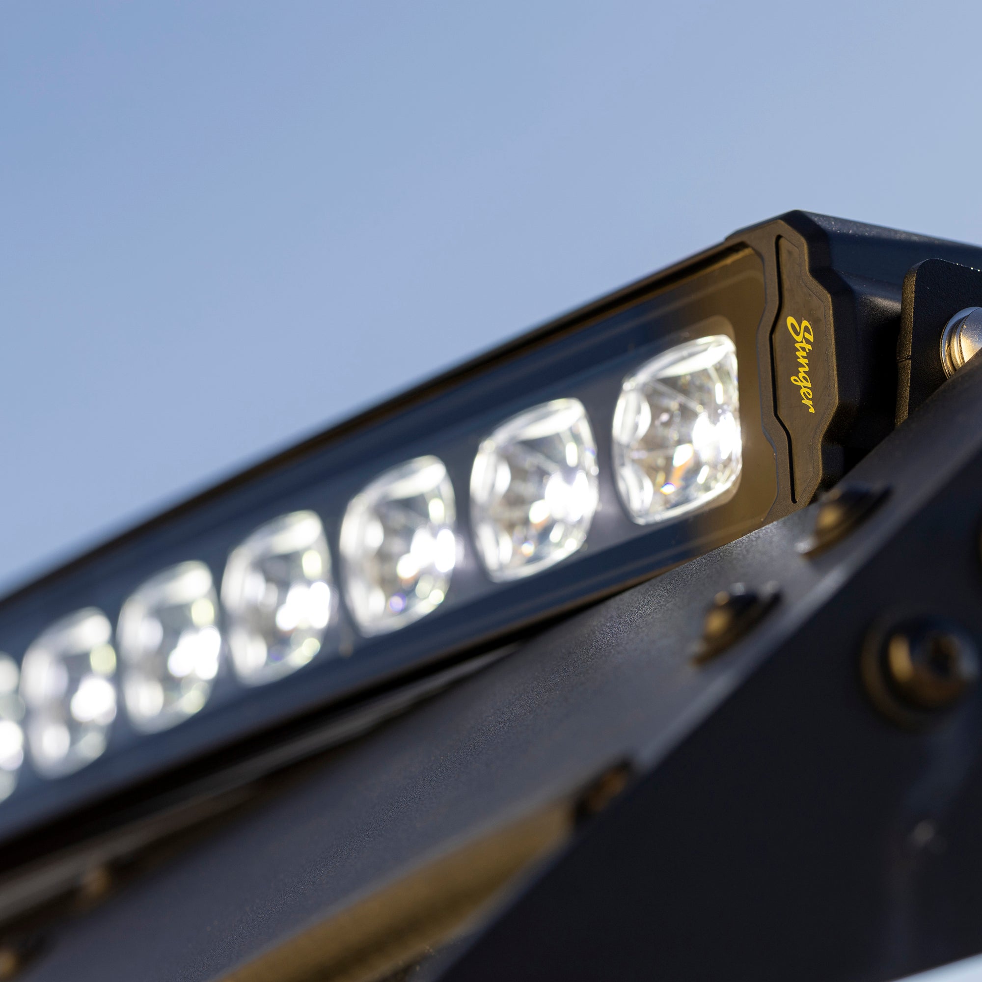 Stinger LED light bar mounted on a vehicle against a blue sky