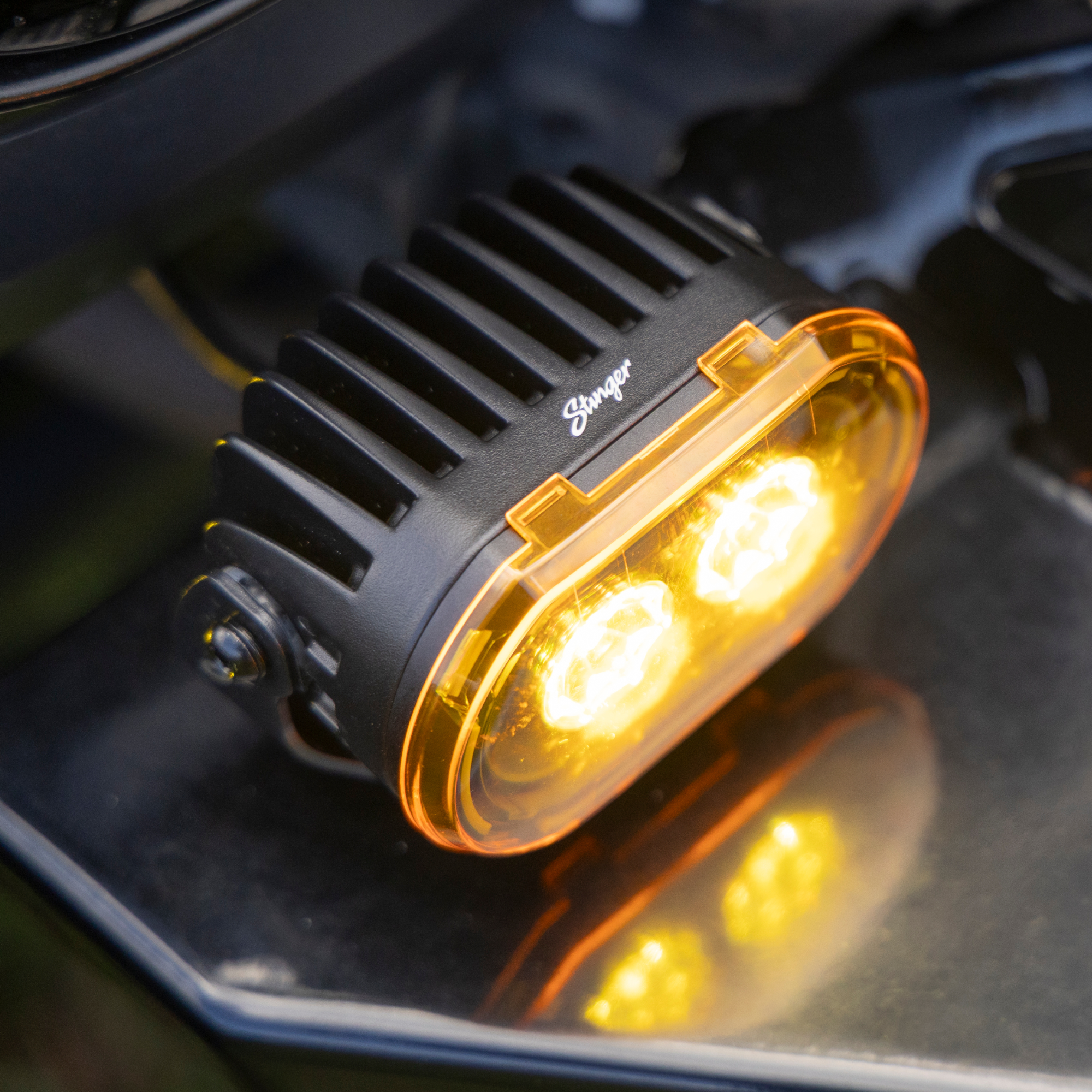 Car pod light with 'Stinger' branding on a dark background