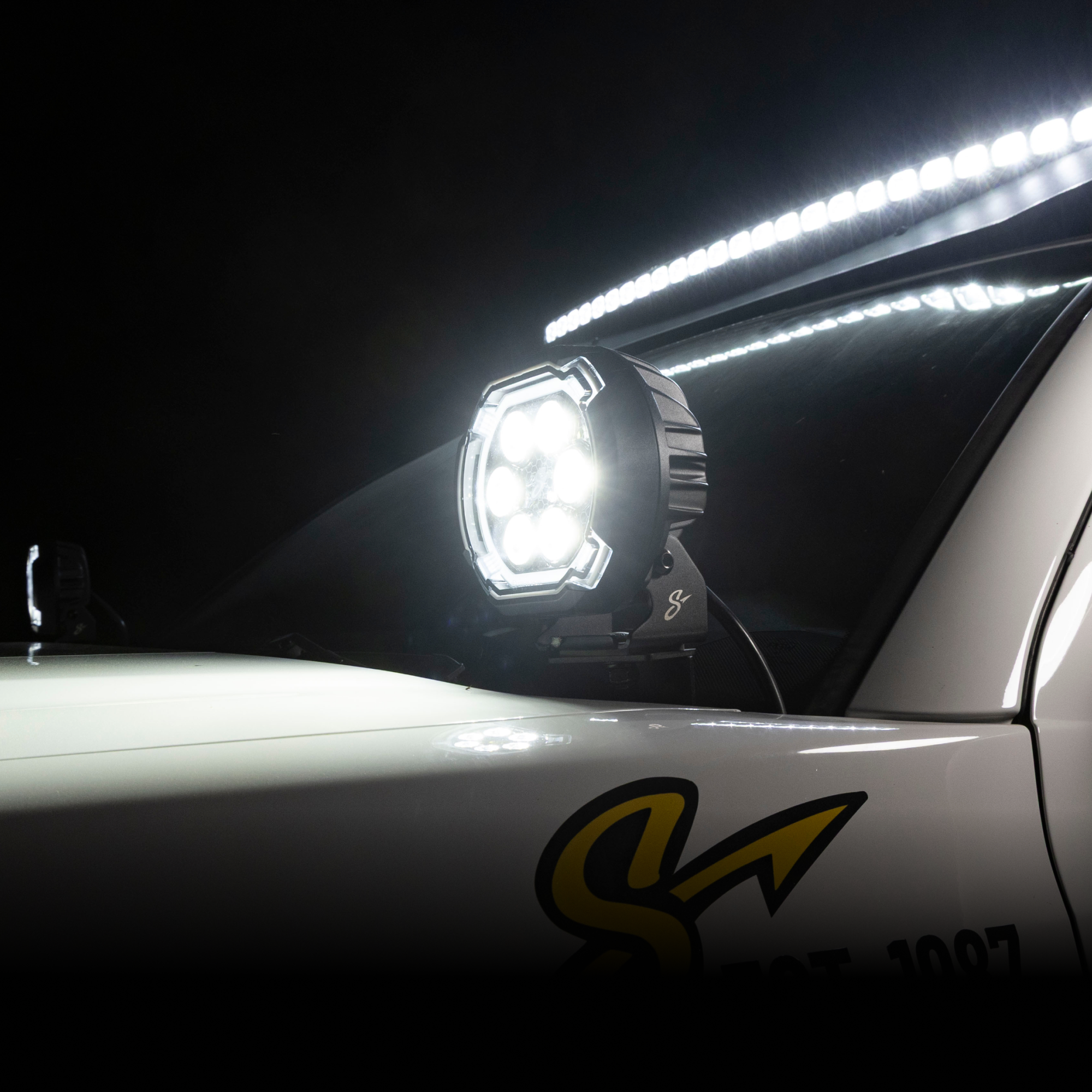 Car with a large LED light on the side at night