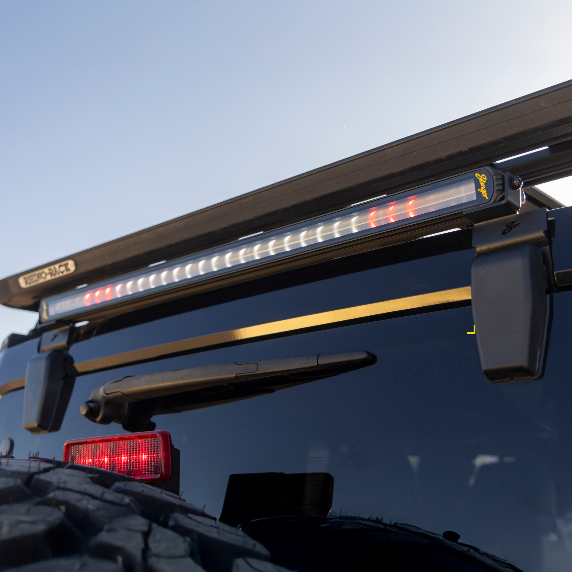 Stinger LED light bar mounted on a Rhino Rack roof rack on a vehicle rear
