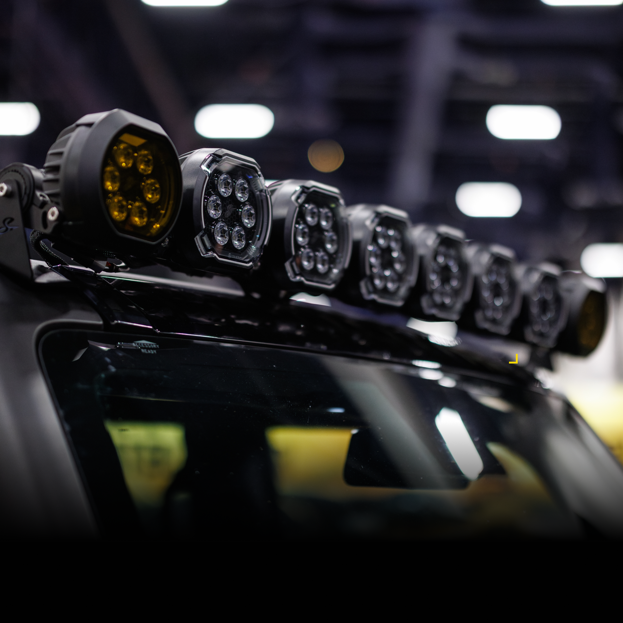 Row of circular LED off road lights mounted on a vehicle roof rack