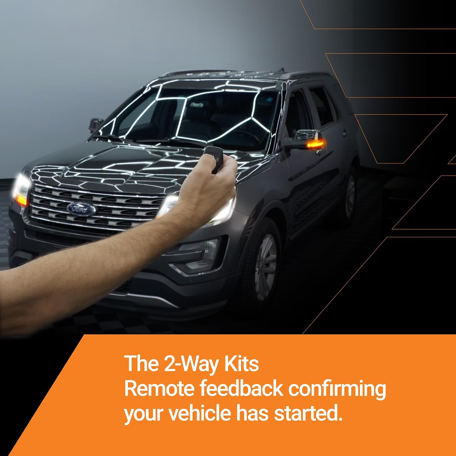 A dark gray Ford SUV shown at an angle with a person's arm extended toward the windshield, demonstrating a remote feedback feature. The image includes an orange text banner at the bottom that reads, 'The 2-Way Kits Remote feedback confirming your vehicle has started.