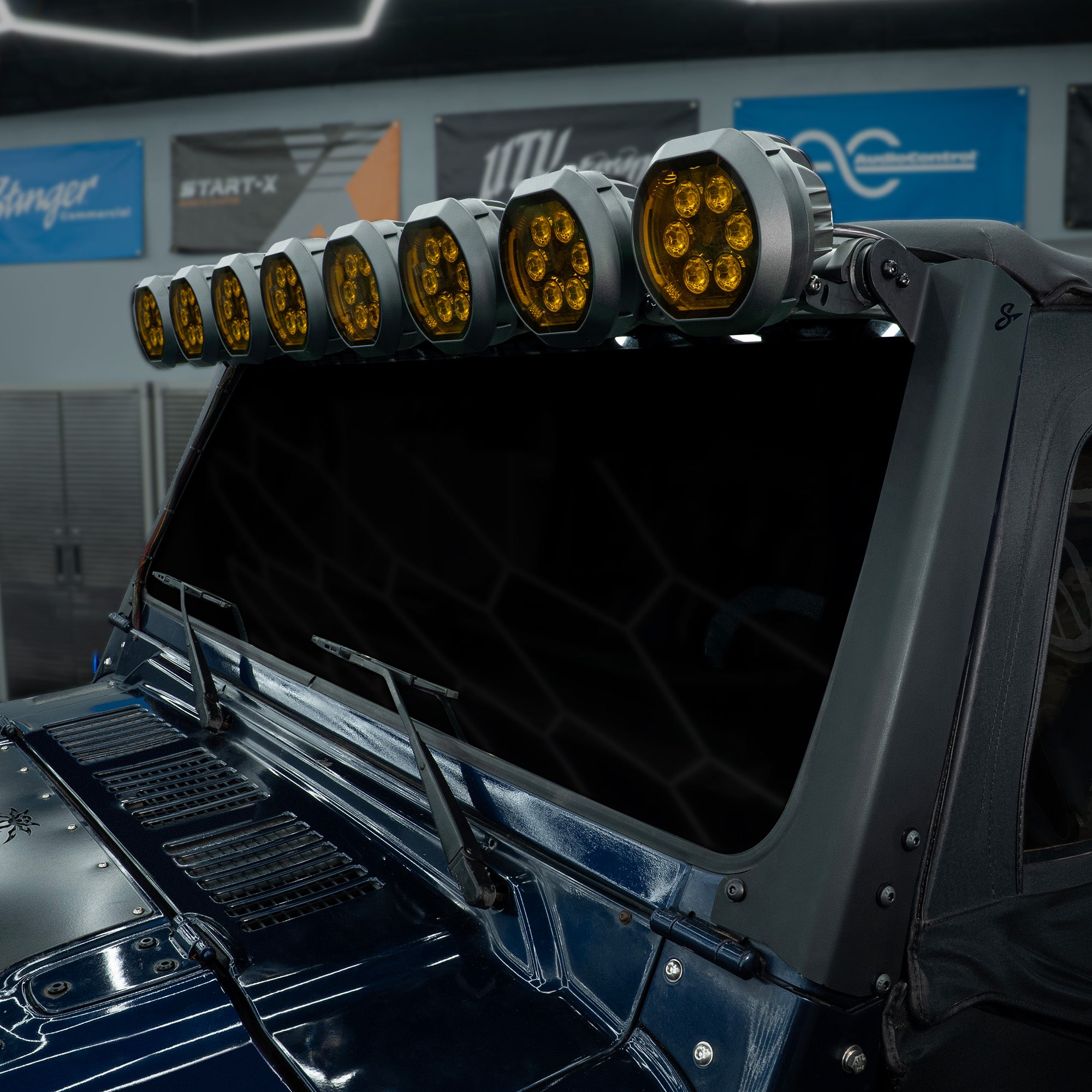 Stinger LED light bar with amber lenses mounted above a vehicle windshield