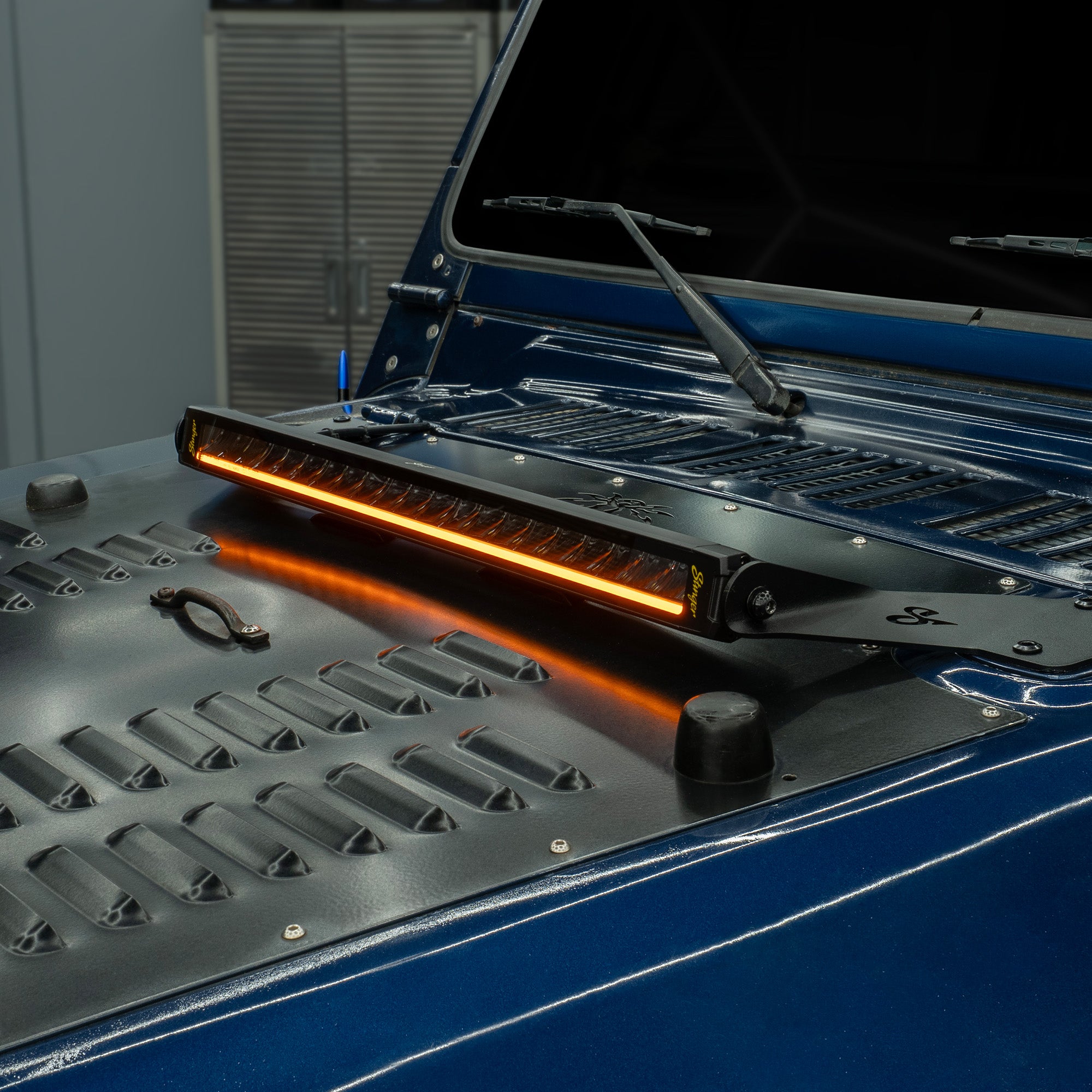 Stinger LED light bar mounted on a blue vehicle hood