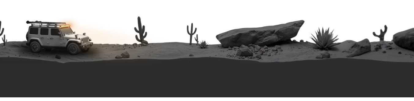 Desert landscape with a vehicle, cacti, and rocks under a sunset sky.