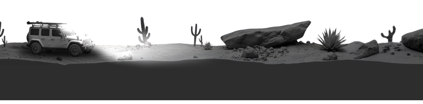 Desert landscape with a vehicle, cacti, and rocks.