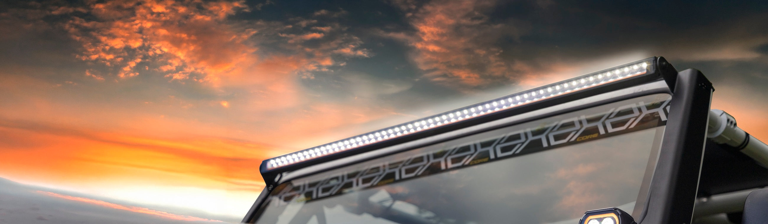 LED light bar on a vehicle with a sunset sky in the background