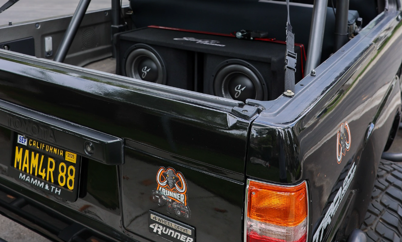 Black Toyota 4Runner with audio equipment in the bed, California license plate